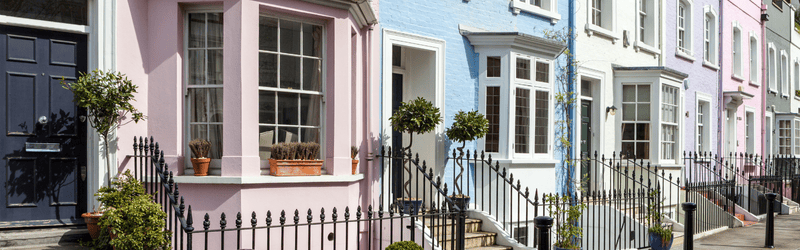 can i buy a house in the uk while living abroad, multi-coloured terrace houses in Notting Hill,